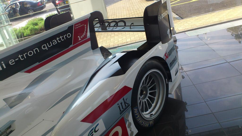 Illustration for article titled Audi R18 E-Tron (was) parked at Volkswagen Financial Services lobby